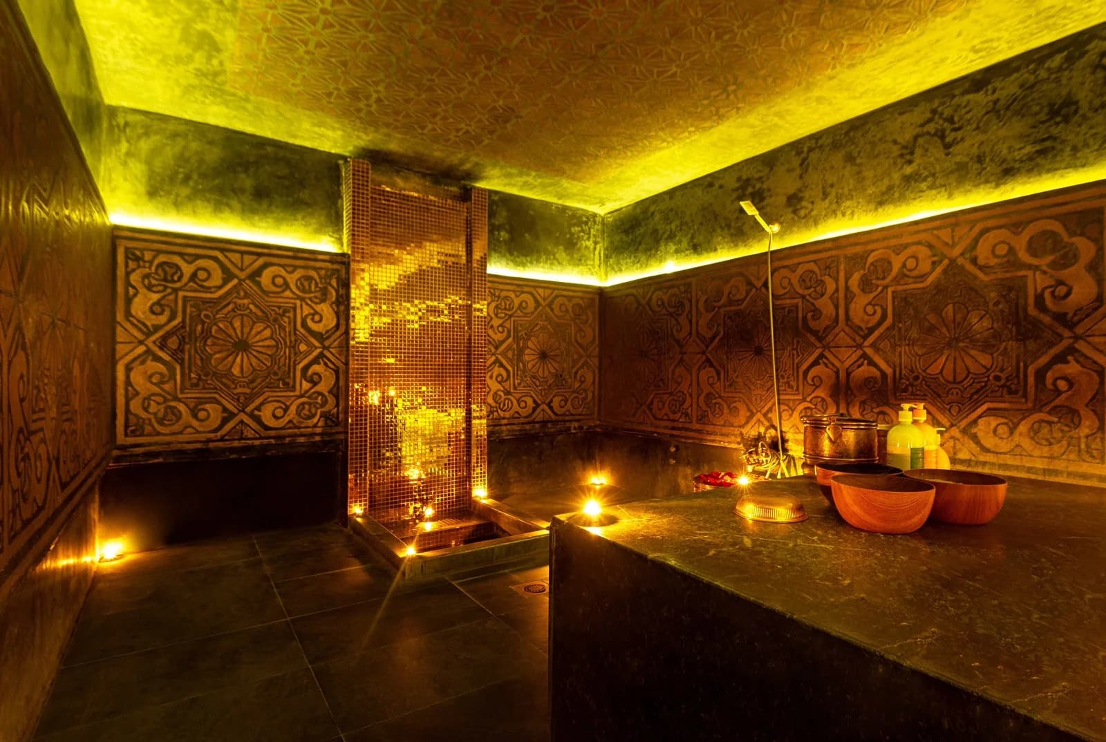 Traditional hammam with golden lighting and Moroccan tiles