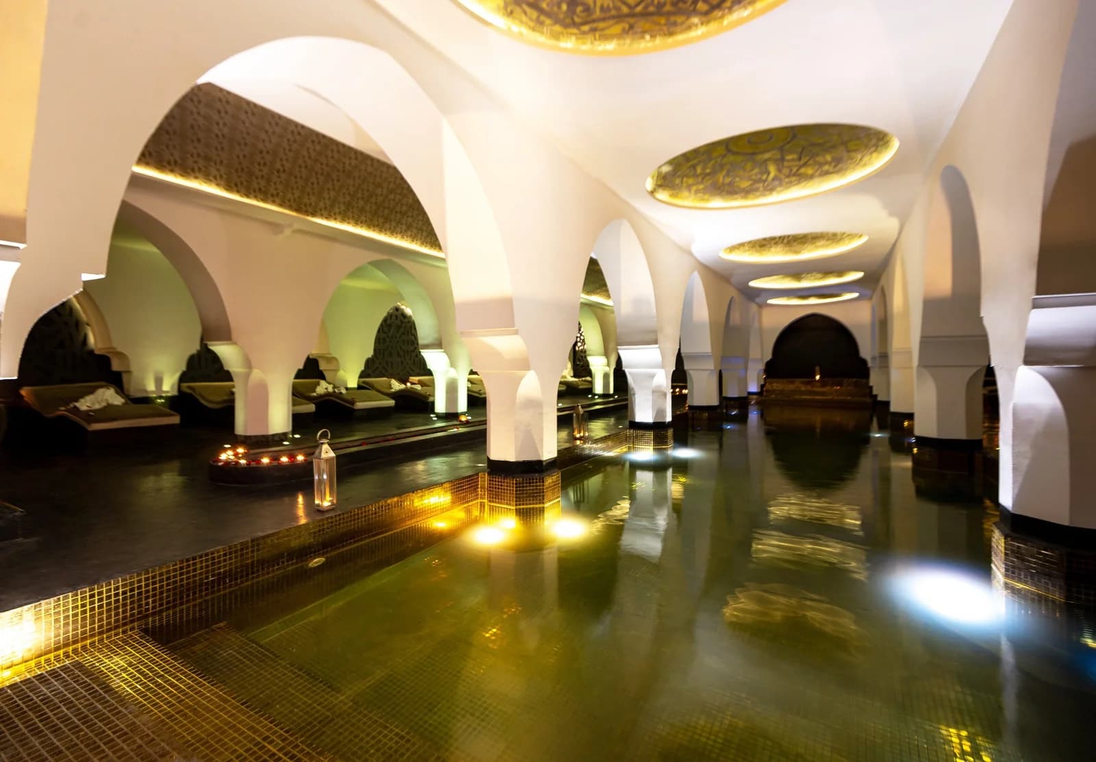 Indoor heated pool with reflective water and atmospheric lighting