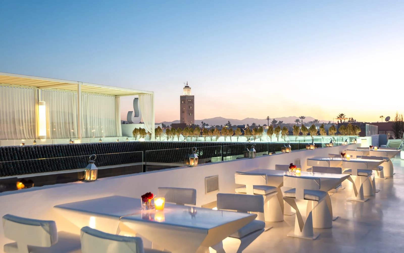 Rooftop dining at dusk with Koutoubia mosque view