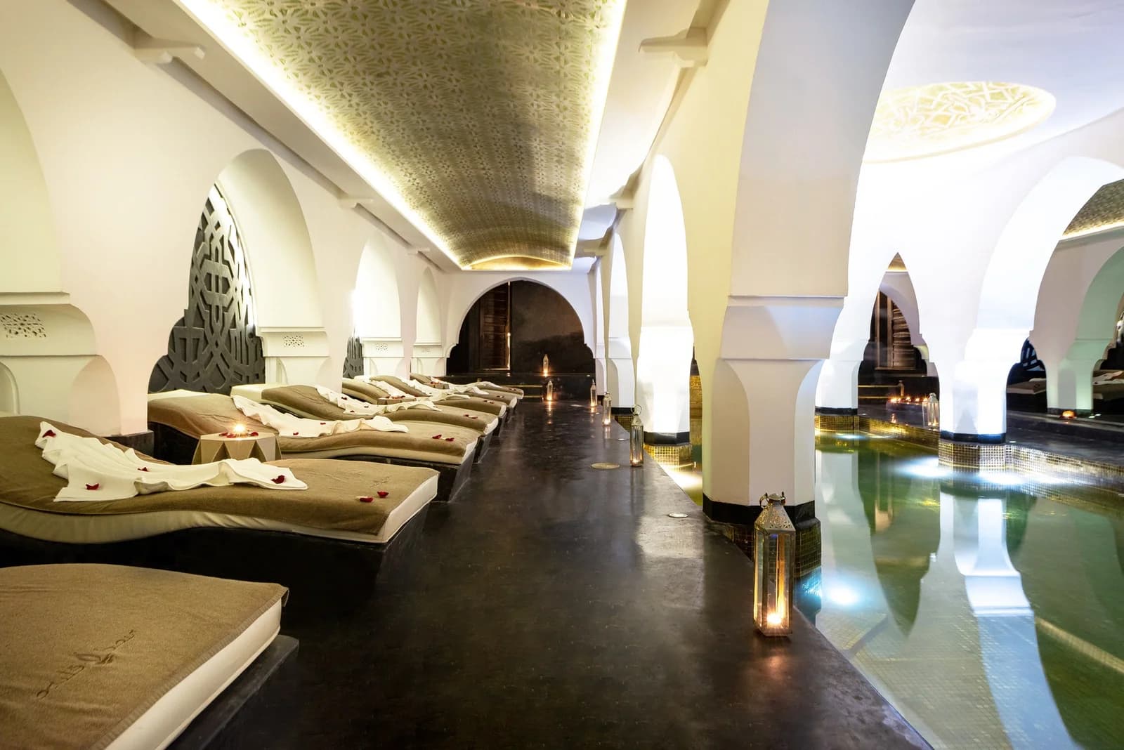 Riad Elisa spa with heated pool, white arches and relaxation loungers